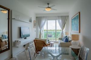 ein Wohnzimmer mit einem Glastisch und einem Sofa in der Unterkunft Xeliter Cana Rock Punta Cana in Punta Cana