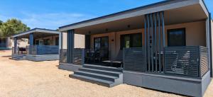 a house with blue shutters on the side of it at Adriaticoast Holiday Apartments- Dalmatian Dream in Drage +32 photos