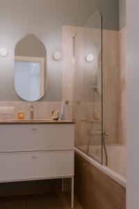 a bathroom with a shower and a sink and a mirror at Forest Zen Sopot z widokiem na morze - Praia Apartments - Polsat Plus Arena in Sopot