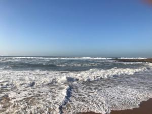 a view of the ocean from the beach at Atlantic Waves Accommodation in Carcavelos