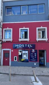 a red building with a hostel sign on it at Hostel Vasco Da Gama in Lagos