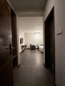 a hallway of a hotel room with a bed and a couch at The Ivory Hotel in Nairobi +56 photos