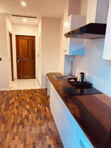 a kitchen with a counter and a sink and a door at Flora Hotel Ivato International Airport in Antananarivo