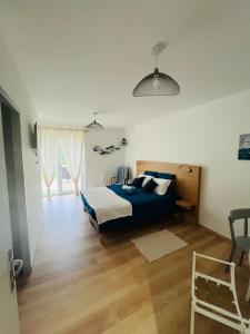 a bedroom with a blue bed in a room at Chambres d'hôtes Les Vernayes in Amplepuis +20 photos