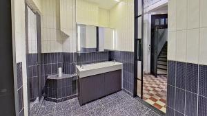 a bathroom with a sink and a mirror at Habyt Bridges - 6-8 Wa In Fong Street in Hong Kong