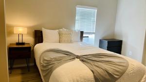 a bedroom with a bed with a bow on it at Great location in Midtown! in Houston