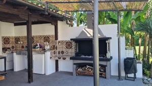 a kitchen with an outdoor oven in a patio at Villa Dimitris in Paralia Panteleimonos