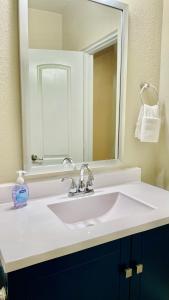 a bathroom with a white sink and a mirror at Great location in Midtown! in Houston