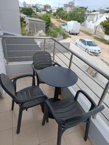 two chairs and a table on a balcony at Villa Kleo Ksamil in Ksamil