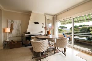 a living room with a table and chairs and a window at Spacious apartment in Sainte-Maxime in Sainte-Maxime