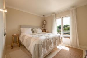a bedroom with a bed and a large window at Spacious apartment in Sainte-Maxime in Sainte-Maxime