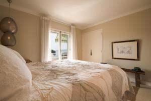 a bedroom with a large white bed with a window at Spacious apartment in Sainte-Maxime in Sainte-Maxime