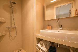 a bathroom with a white sink and a mirror at Spacious apartment in Sainte-Maxime in Sainte-Maxime +13 photos