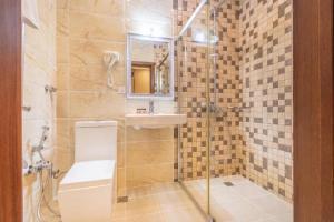 La salle de bains est pourvue de toilettes, d'un lavabo et d'une douche. dans l'établissement Maestro Hotel, à Baku