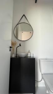a bathroom with a sink and a mirror on the wall at Villa Trentino Chalé Pirineus in Teodoros +21 photos