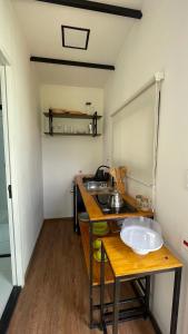 a small kitchen with a sink and a counter at Villa Trentino Chalé Pirineus in Teodoros +17 photos