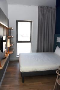 Кровать или кровати в номере ibis budget Langres