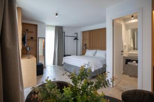 a bedroom with a bed and a living room at Griffin Suites in Heraklio