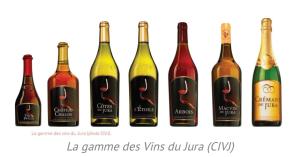 a group of wine bottles in a row at La jurassienne in Champagnole