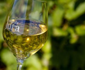 a wine glass with white wine in it at La jurassienne in Champagnole