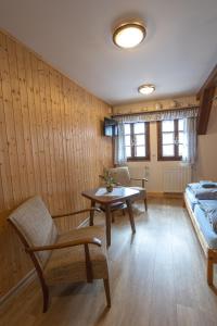 a living room with a table and a couch at Chalupa Maršovka in Horní Maršov