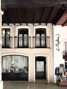 a store front of a building with three windows at La Porticada in Morella