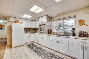 a kitchen with white cabinets and a refrigerator at Cozy Apartment Less Than 4 Miles to Downtown Anchorage! in Anchorage +19 photos