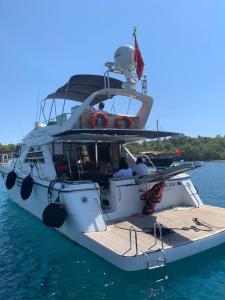 a white boat is docked in the water at luxer holiday in Antalya