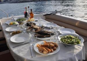 a table with plates of food on a boat at luxer holiday in Antalya