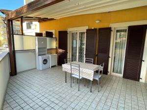 a patio with a table and chairs on a house at Casa vacanze Da Maria in Grottammare +4 photos