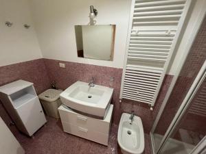 a bathroom with a sink and a toilet and a mirror at Casa vacanze Da Maria in Grottammare