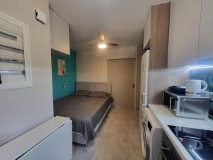 a small kitchen with a bed in a small room at Bovis Apartments #2 in Porto Rafti