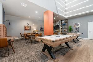 a living room with a ping pong table in it at Locale Fort Worth in Fort Worth