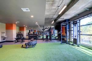 a gym with lots of equipment and a green carpet at Locale Fort Worth in Fort Worth