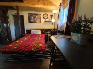 1 dormitorio con 1 cama con edredón rojo en Wolf's Cabin-Walk to Downtown Noblesville, en Noblesville