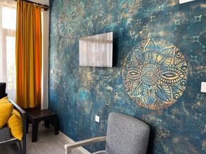 a room with a wall with a painting on it at Konukzade OldTown Apart in Antalya