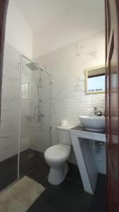 a bathroom with a toilet and a sink and a shower at Coral Village Toby in Santa Bárbara de Samaná