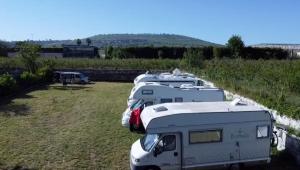 a row of parked rvs parked in a field at Sosta Camper e Roulott L’Amour in Naples