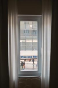 a window with a view of a group of people at Apulia Rooms Bari in Bari