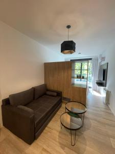 a living room with a couch and a glass table at Departamento Nuevo en Palermo Soho in Buenos Aires