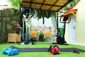 a gym with exercise equipment on the grass at Thassion-ikea Feels Like Home in Astris