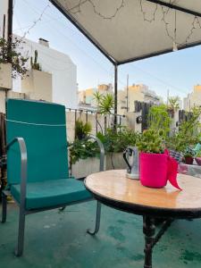 a table and a chair on a patio at Amplia Habitacion en San Telmo in Buenos Aires