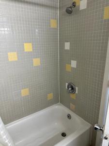 a bathroom with a shower with a tub at Bravo Inn Greensboro in Greensboro