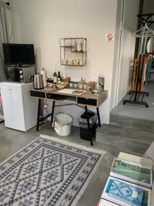 a kitchen with a table and a counter top at Modern Stylish room Linkside in Mossel Bay