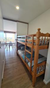 two bunk beds in a room with a table at super appartement vue port Camargue- Le Grau Du Roi in Le Grau-du-Roi +4 photos