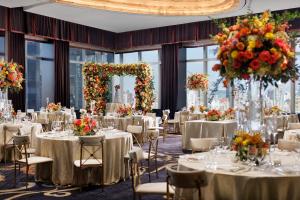 - une salle de banquet avec des tables, des chaises et des fleurs dans l'établissement Mandarin Oriental, New York, à New York