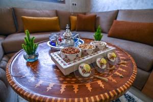 a coffee table with a tray of food on it at The Skyline Stay in Marrakech