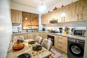 a kitchen with wooden cabinets and a table with chairs at The Skyline Stay in Marrakech +13 photos