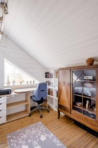a bedroom with a desk and a chair in a room at 3 Bedroom Cottage with Sauna by the Sea in Vaasa