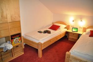 a bedroom with two beds and two night stands at Landhaus Harmonie in Arnbruck +69 photos